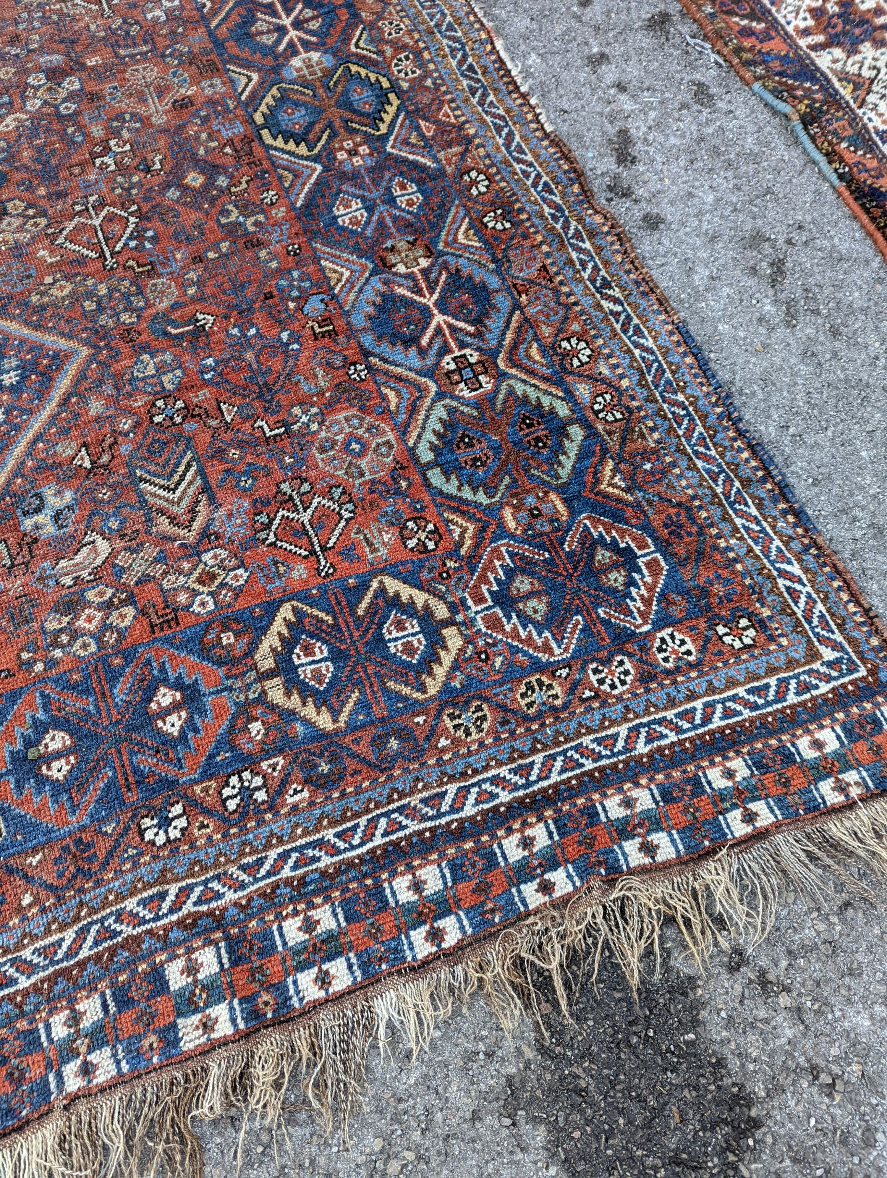 A Caucasian red ground carpet, 295 x 220cm
